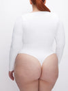 Good American Scuba Scoop Long Sleeve Bodysuit in white thong